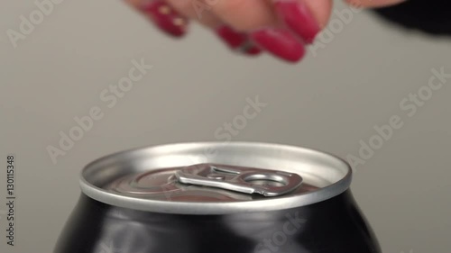 The girl opens a beer can. Slow motion. Close-up