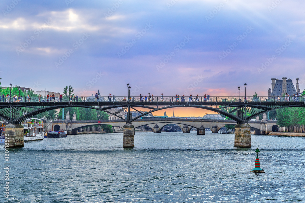 Paris cityscape, view pedestrian bridge at Seine river from Cite island, several bridges vista. France.