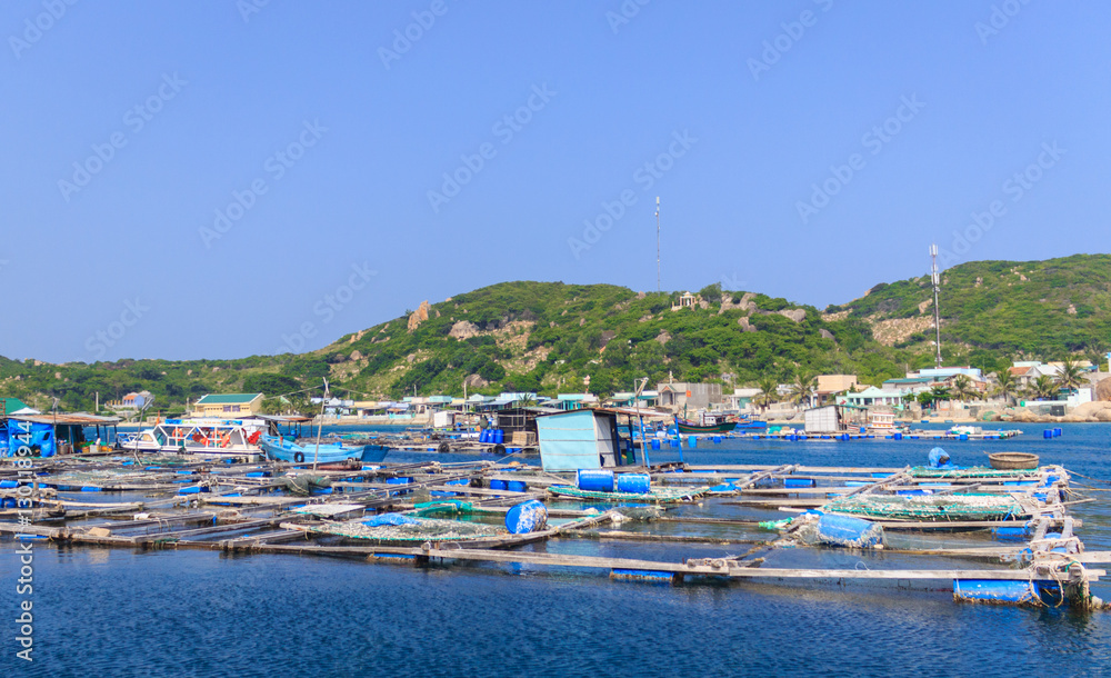 Floating nets of fishs farm in a natural bay. Floating nets of fishs farm in a natural bay.