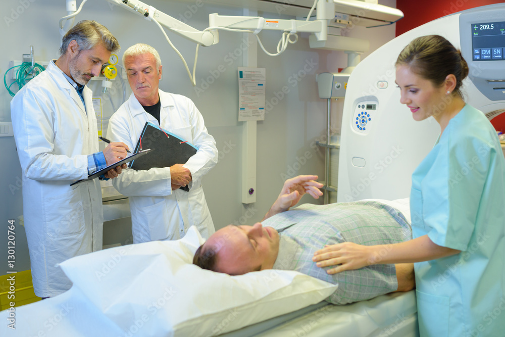Nurse reassuring patient having scan Nurse reassuring patient having scan