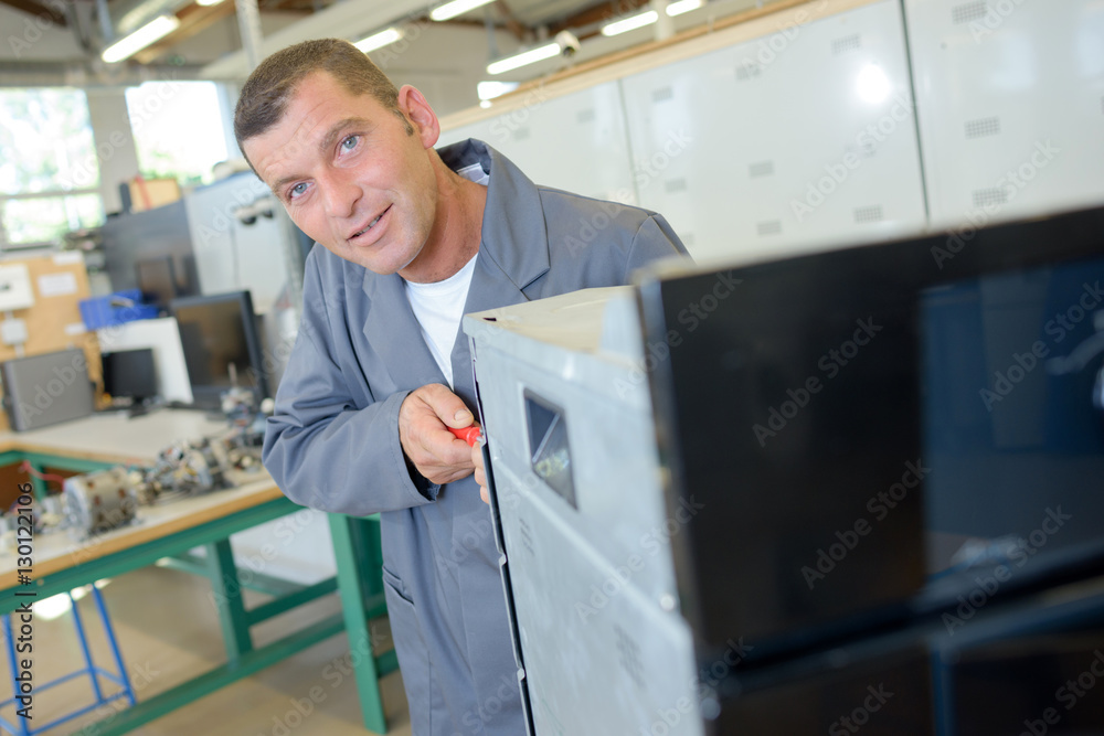 Fototapeta premium Repairman working on oven