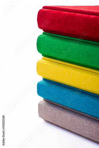 Multicolored book textile cover. Photobooks on a white background.