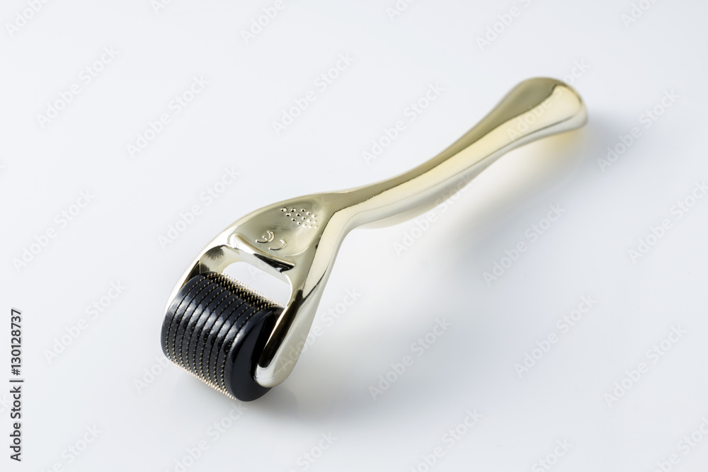 Golden derma roller for medical micro needling therapy. Tool also known as: Derma roller, mesoroller, meso-roller, mesopen. Golden derma roller for medical micro needling therapy. Tool also known as: Derma roller, mesoroller, meso-roller, mesopen.