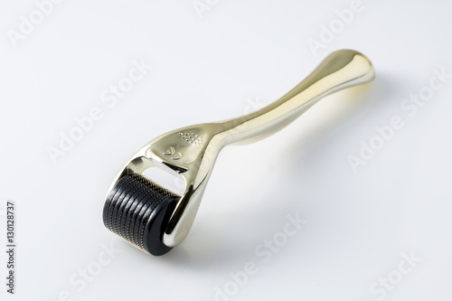 Golden derma roller for medical micro needling therapy. Tool also known as: Derma roller, mesoroller, meso-roller, mesopen.