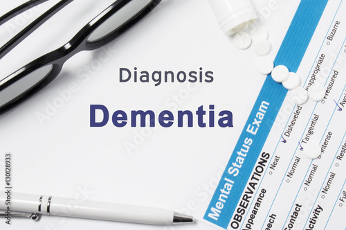 Diagnosis of Dementia. Results of mental status exam, container with crumbled pills with inscription psychiatric diagnosis Dementia on white background or white workplace psychiatrist or psychologist photo