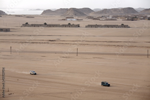 Jeeps cover the wide expanse of desert between Lake Nasser and the town of Wadi Halfa, Sudan photo