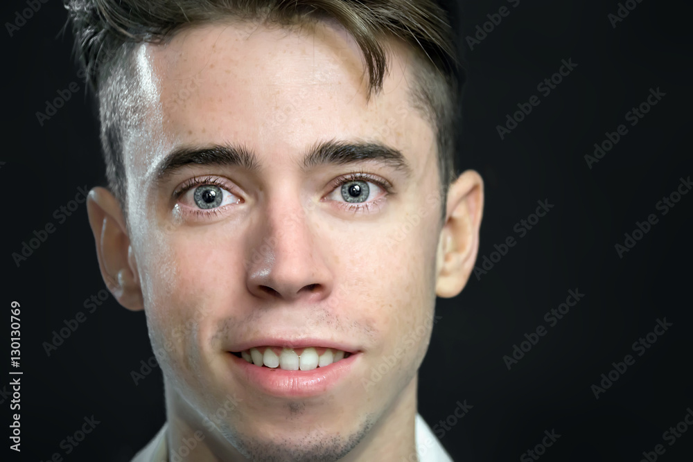 Fototapeta premium Handsome young man close portrait over black background