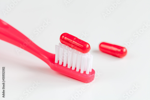 concept toothache with toothbrush and tablet at white background