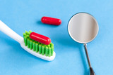 concept tooth pain - dentist tools, tablet at blue background