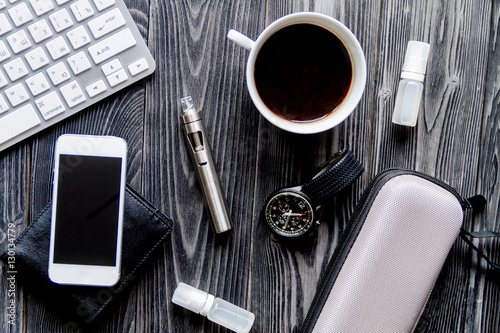 coffee, electronic cigarette, mens accessories dark wooden background top view