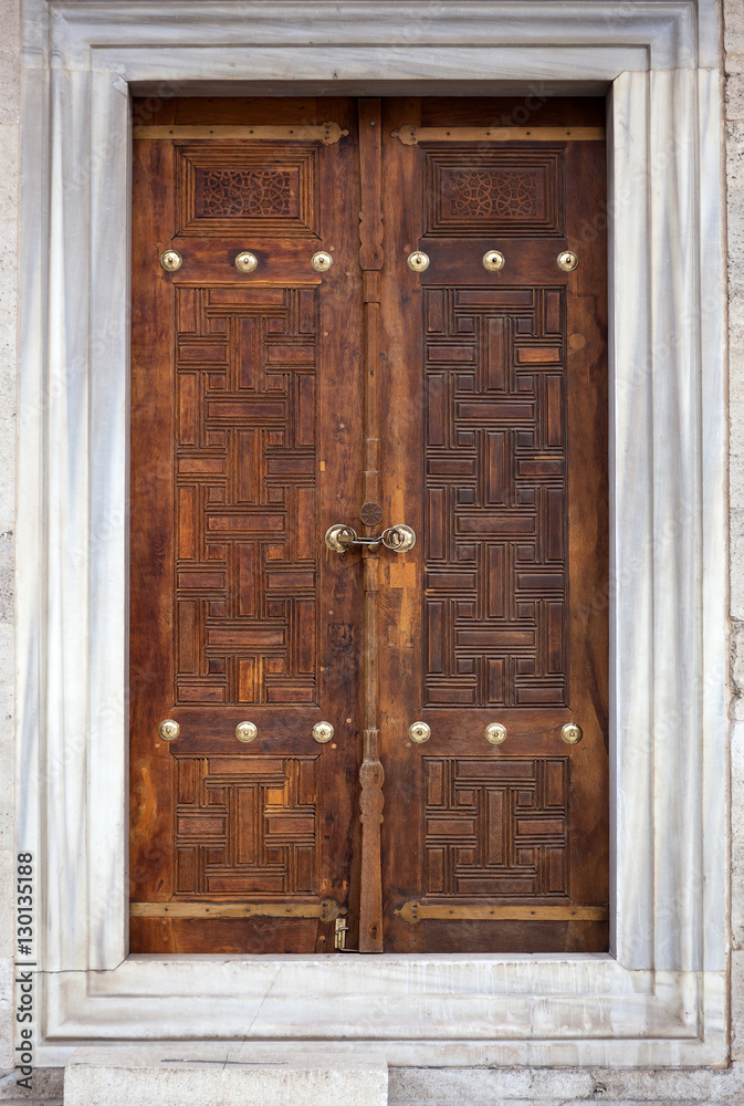 An old wood door with metal handle. An old wood door with metal handle.