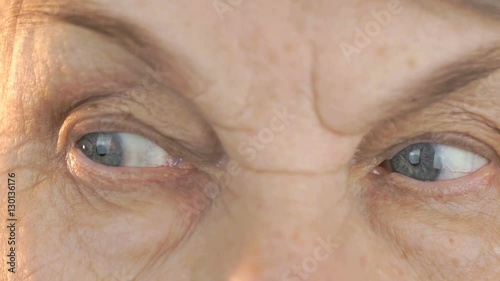 Elderly woman's face with tired expression of face. Close up photo