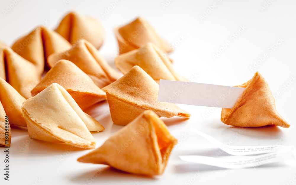 Chinese fortune cookie with prediction on white background Chinese fortune cookie with prediction on white background