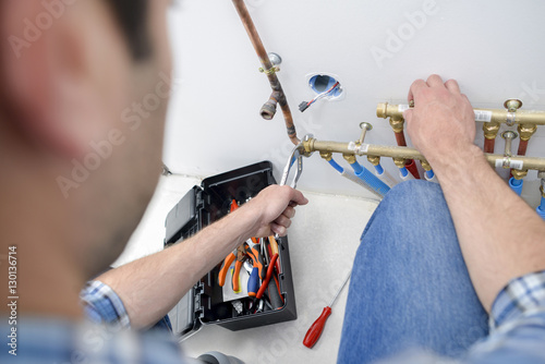 Man working on water pipes photo