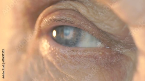 Blue eye of a middle-aged woman. Close up photo