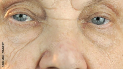 Elderly woman's face with tired expression of face. Close up photo