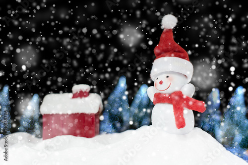 Snowman on snow pile and bokeh tree on dark night background hol © Love the wind