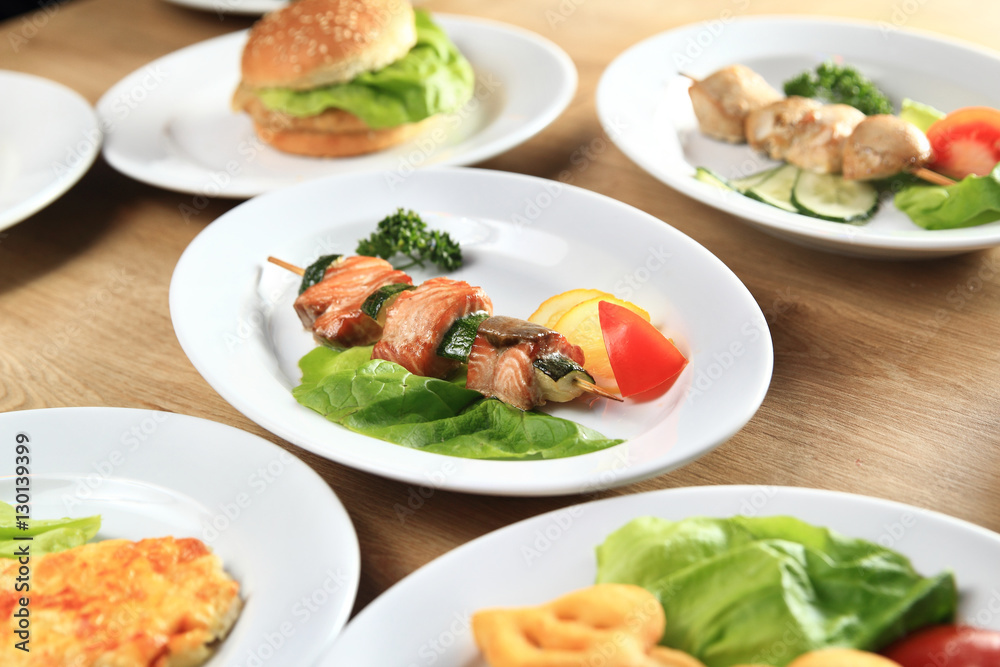 kebab,Burger and salads on the table in the restaurant kebab,Burger and salads on the table in the restaurant