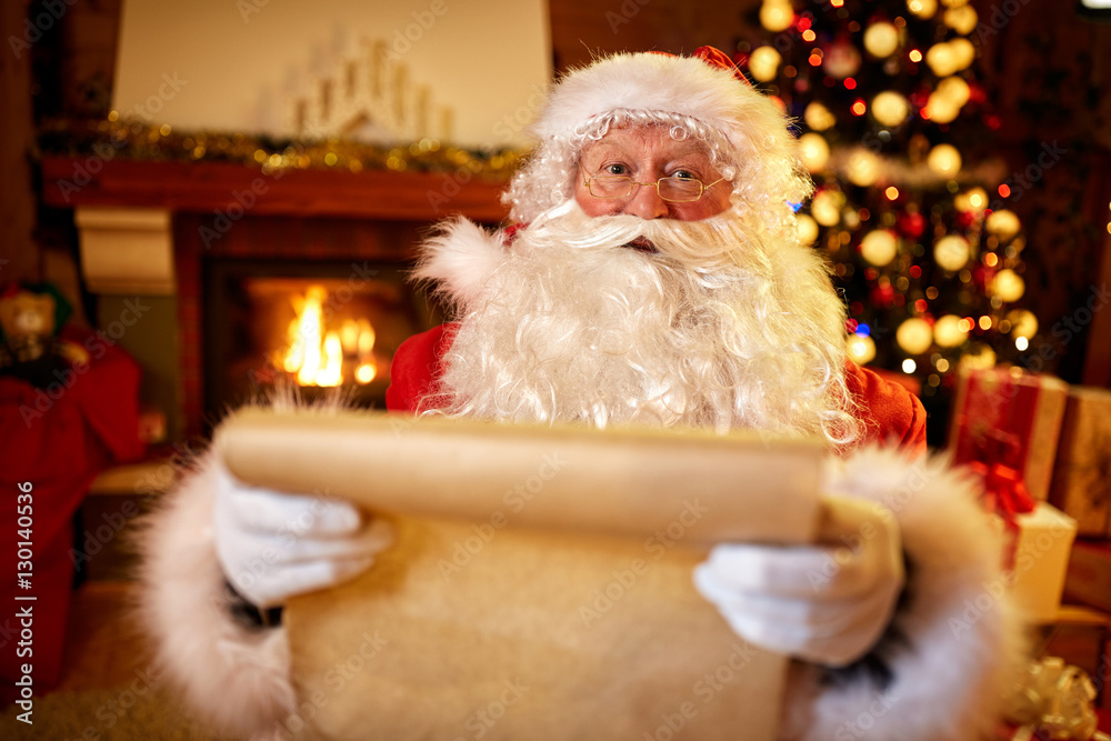 Santa Claus with a list of children wishes Santa Claus with a list of children wishes