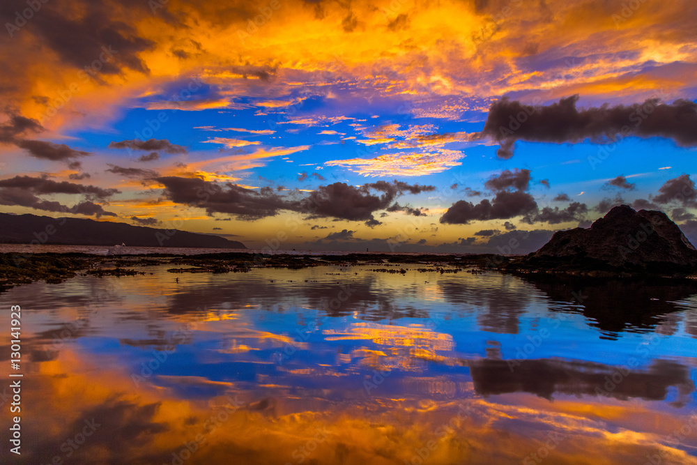 Beautiful Hawaiian sunset reflected in tide pool on the North Shore of Oahu