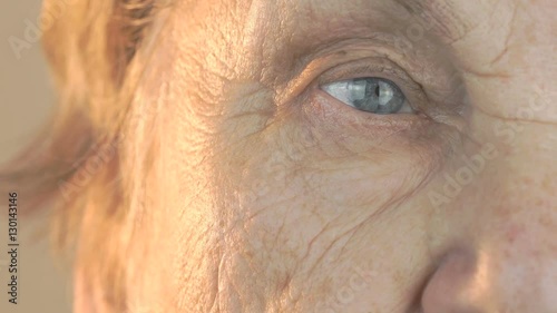 Elderly woman's face with disturbing look of face. Close up photo