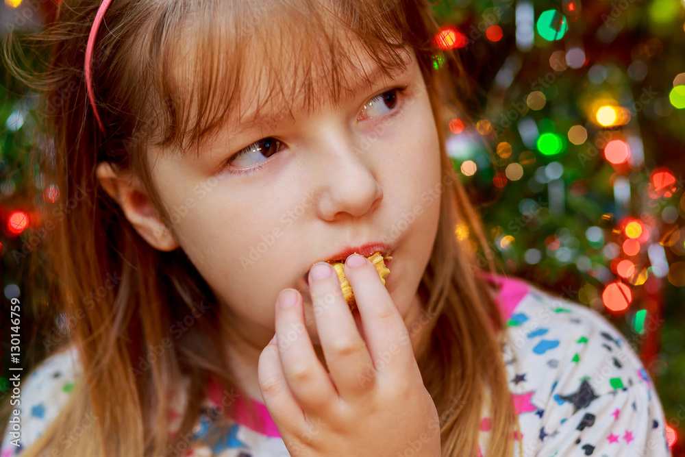 cute little girl eats cake sakotis new year and merry christmas background cute little girl eats cake sakotis new year and merry christmas background
