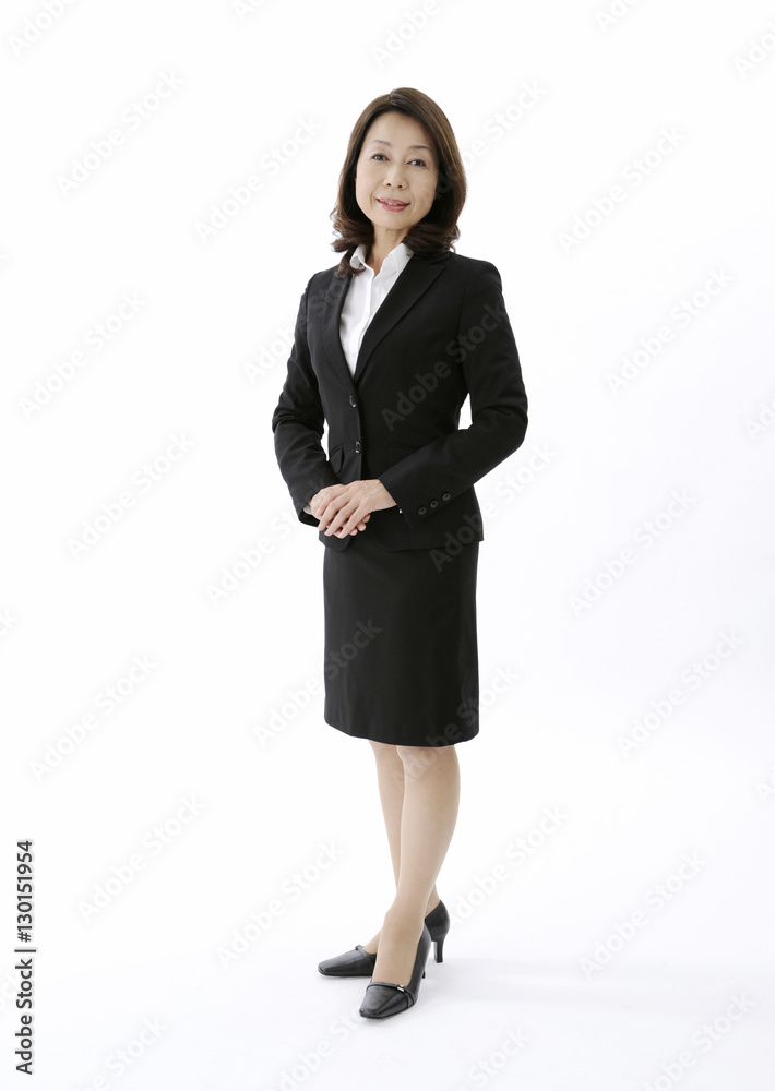 Concierge standing with her hands clasped Concierge standing with her hands clasped