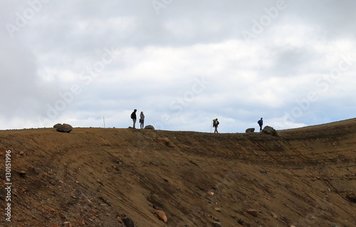 hikers standing on summit of tongariro alpine crossing photo