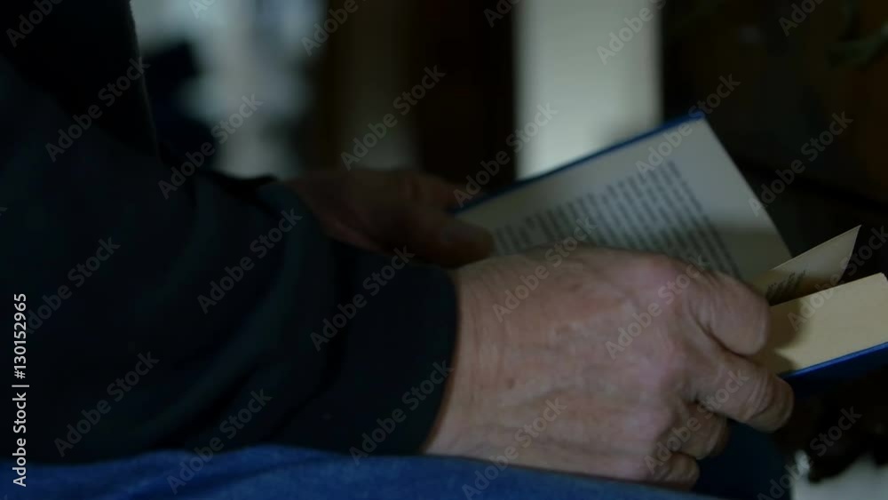man sat on a chair reading a book, hardcover man sat on a chair reading a book, hardcover
