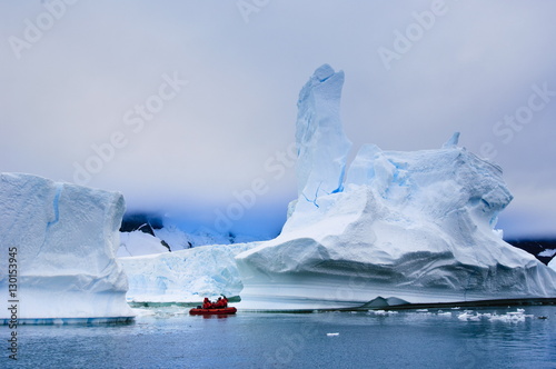 Passengers exploring icebergs near Pl?neau Island, Antarctica photo