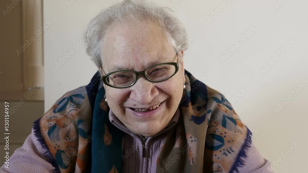 old woman sat not on a chair smiling for a joke, happy old woman sat not on a chair smiling for a joke, happy
