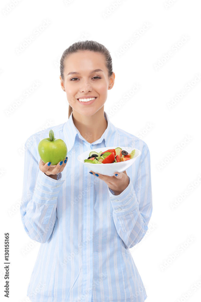 Portrait of a beautiful woman doctor holding plate with fresh vegetables and green apple Portrait of a beautiful woman doctor holding plate with fresh vegetables and green apple
