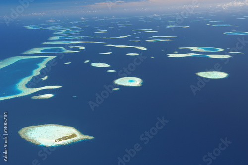 Aerial view of atolls and islands in The Maldives photo