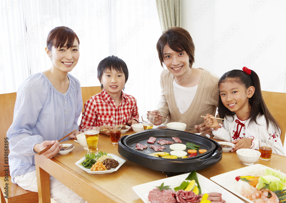 Parents and kids eating Japanese barbeque