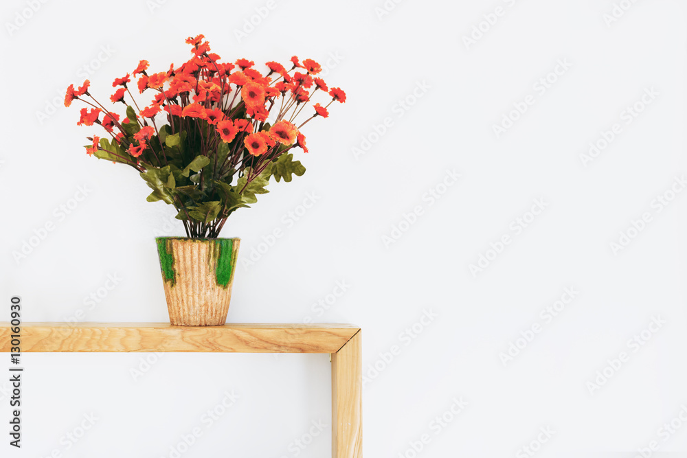 Interior home concept. Virtual orange flowers on wood table with Interior home concept. Virtual orange flowers on wood table with