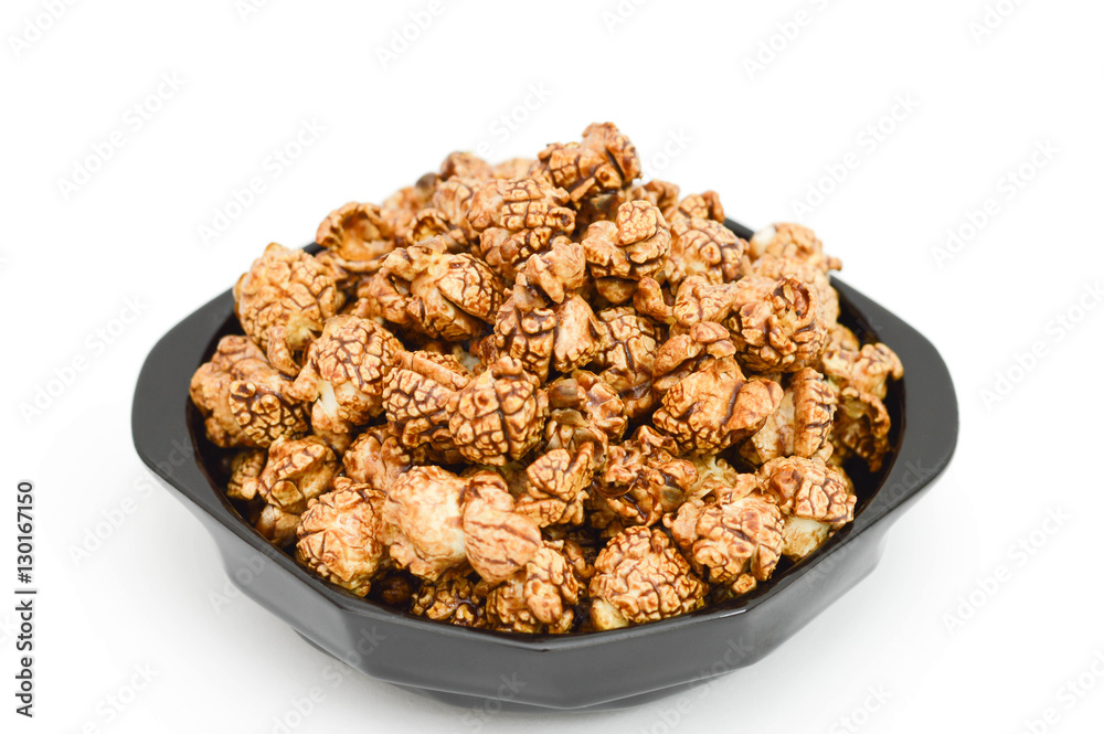 Chocolate popcorn on black plate and white background. Chocolate popcorn on black plate and white background.