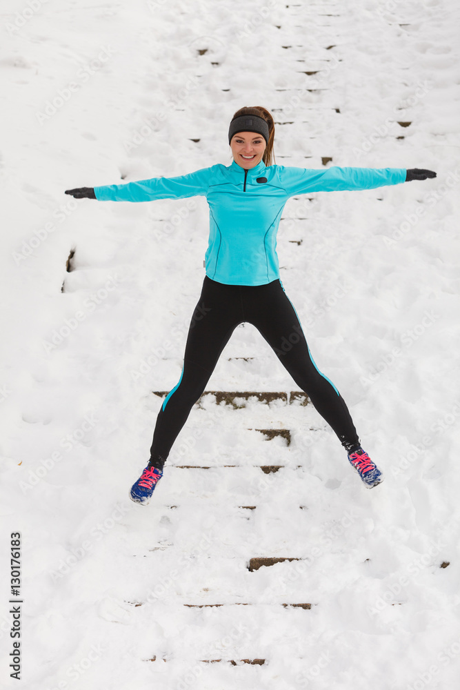 © Voyagerix - Young girl jumping on the snow. © Voyagerix - Young girl jumping on the snow.