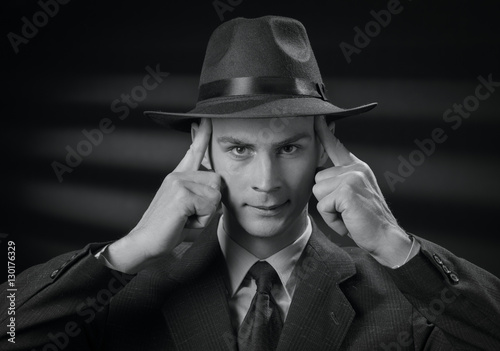 Handsome 1950s style man touching his head