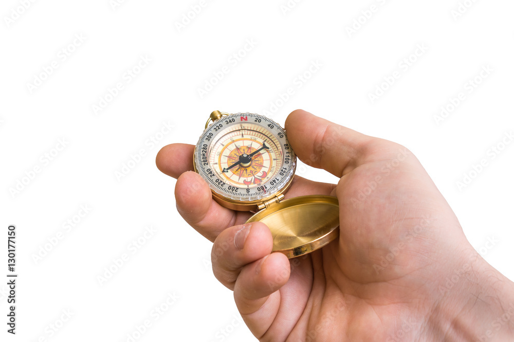 Antique brass compass in a hand isolated on white Antique brass compass in a hand isolated on white