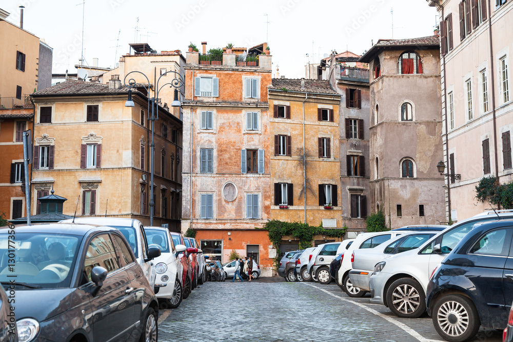 street with old houses and car parking in Rome