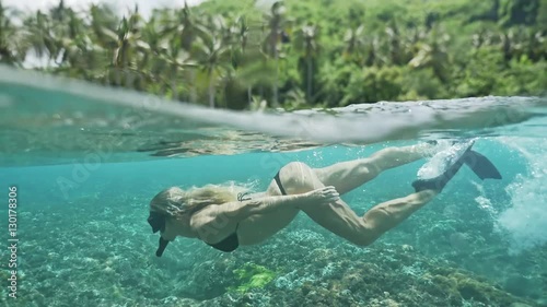Beautiful underwater 50/50 footage of a girl snorkeling in a shalow bay in Nusa Penida, Indonesia. photo
