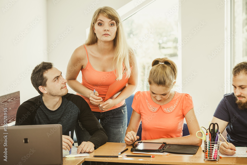 Students and teacher tutor in classroom Students and teacher tutor in classroom