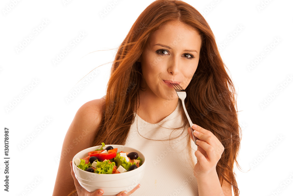 healthy eating - woman eats a bowl of greek salad isolated over healthy eating - woman eats a bowl of greek salad isolated over