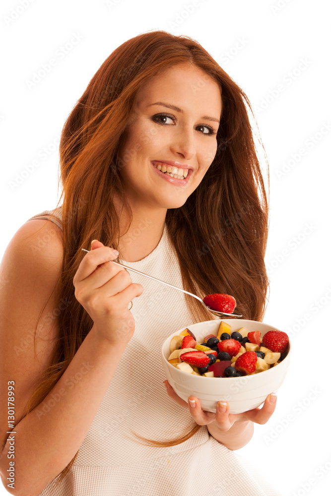 healthy eating - woman eats a bowl of fruit salad isolated over healthy eating - woman eats a bowl of fruit salad isolated over