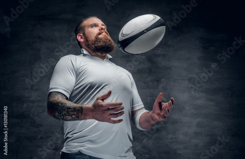 The bearded rugby player catching a game ball.