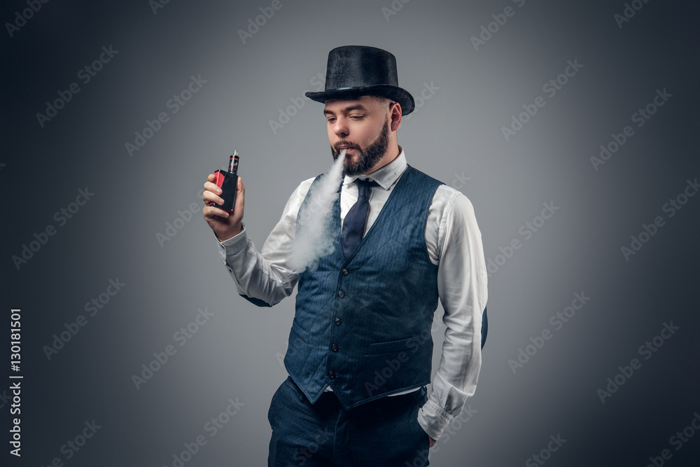 A man smoking an electronic cigarette. A man smoking an electronic cigarette.