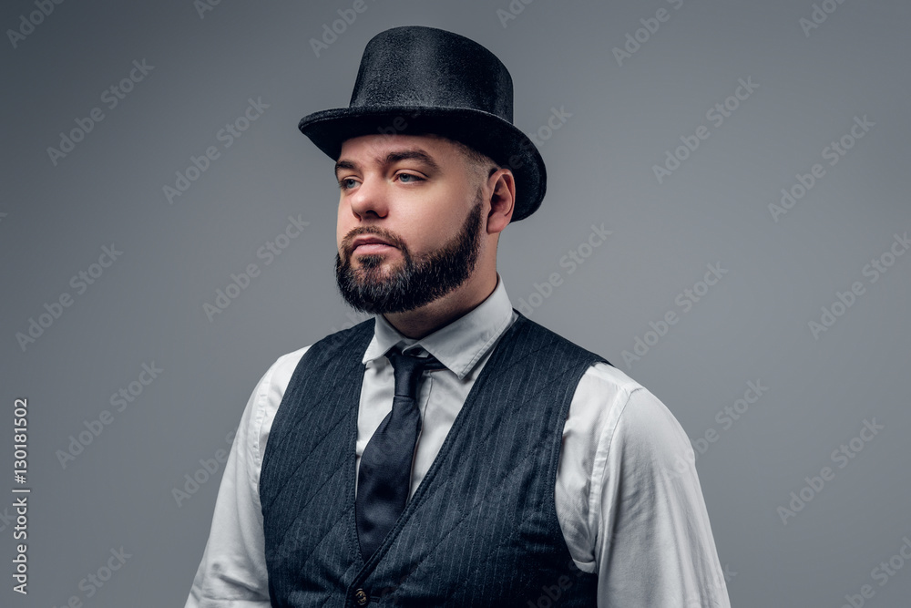 Bearded man wearing cylinder hat and waistcoat.