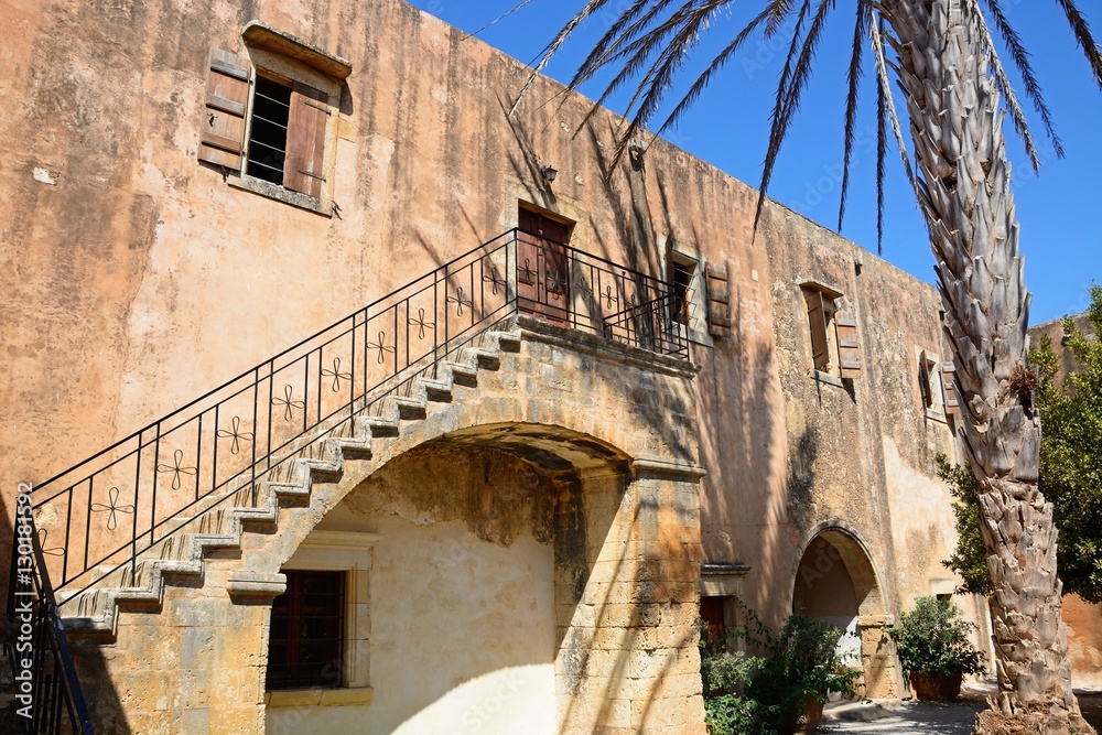 View of the courtyard with ornate stair railings at Arkadi Monastery, Crete.