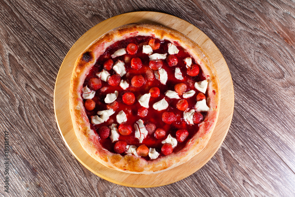 flan with strawberries on a wooden board and background, the con flan with strawberries on a wooden board and background, the con