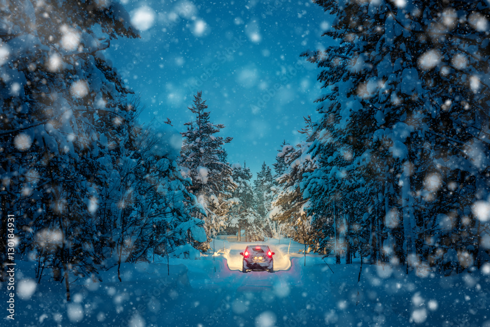 Winter Driving at snowfall night - Lights of car in snowy road